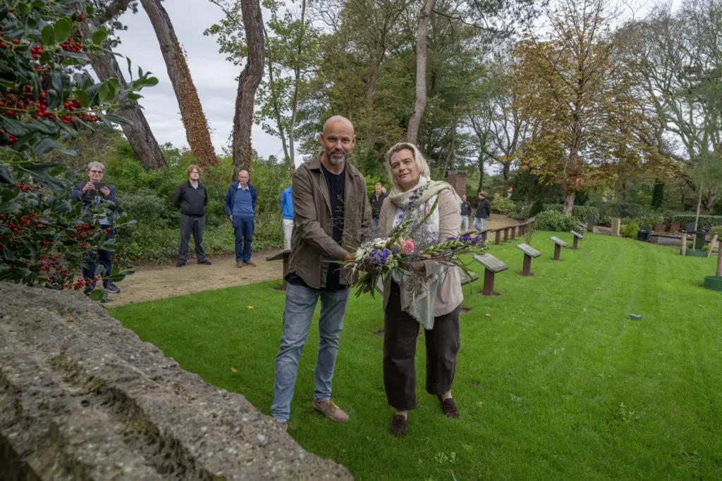 Wethouder Petra Bais en projectleider Rob Noorda leggen bloemen bij monument voor bombardementslachtoffers
